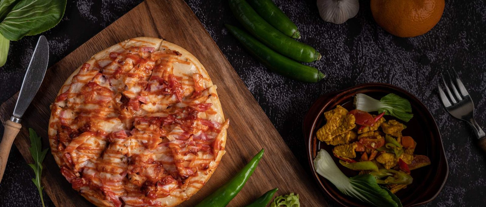 Small pizza on a wooden board with sides