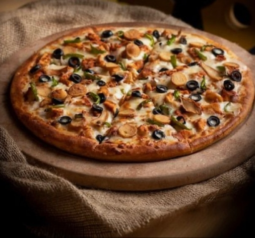 Sliced pizza with chicken, olives, peppers- Crustini pizza