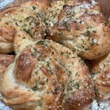 Close-up of golden garlic bread rolls with herbs